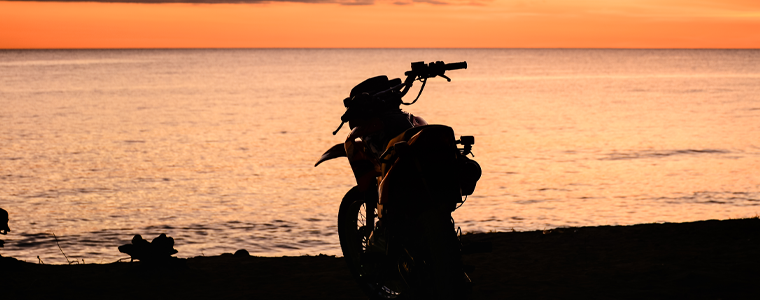motorcycle on beach sunset
