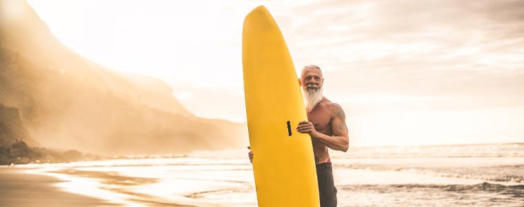 older surfer on the beach