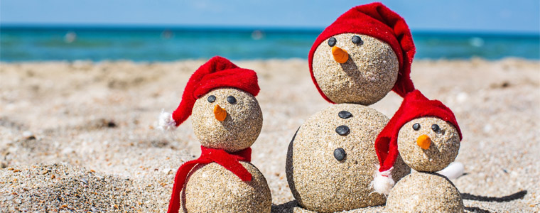 family of sand snowmen beach