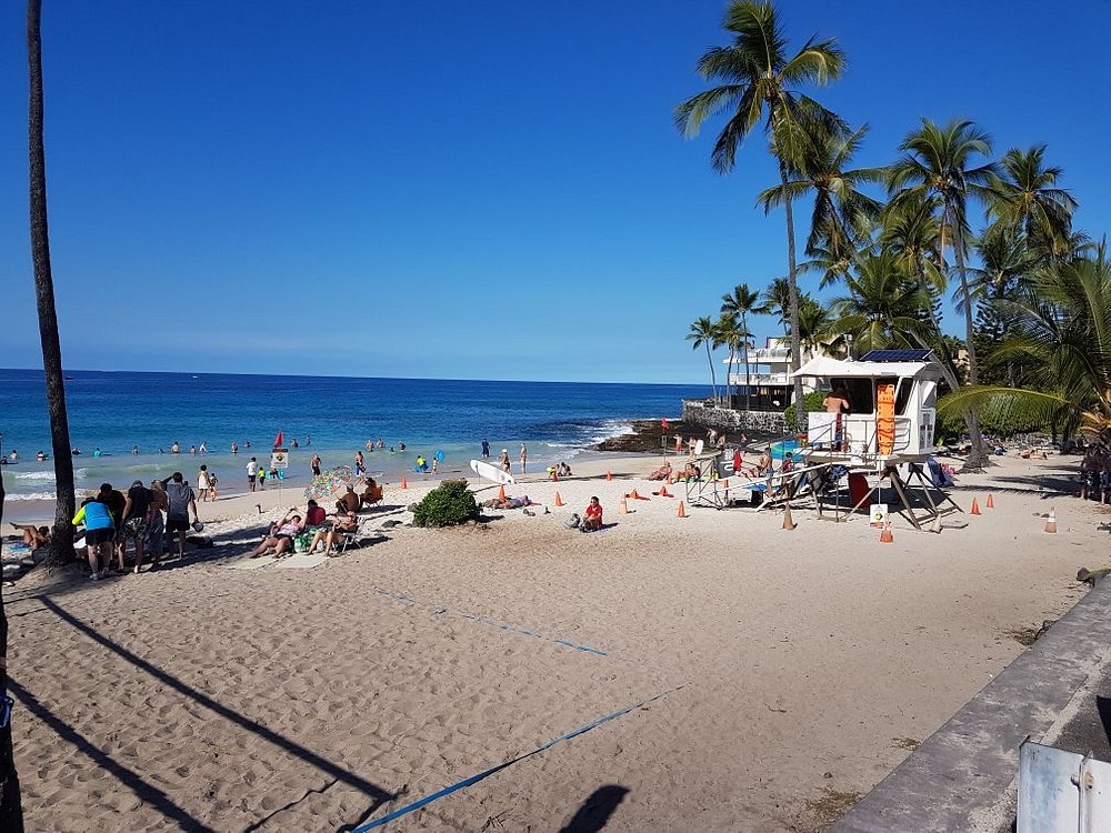 White Sand Beach with people lounging and volleyball court