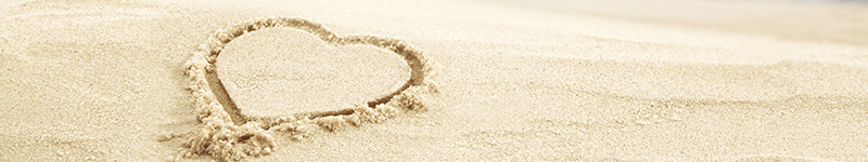 ohana heart drawn into sand on beach