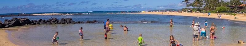 people playing Baby Beach Poipu on Kauai