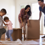 family unpacking moving boxes