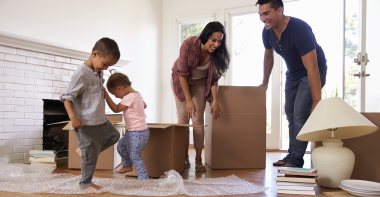 family unpacking moving boxes